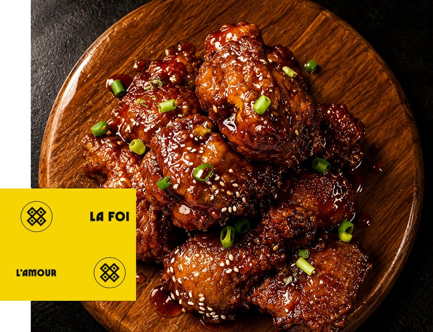 Glazed sesame chicken on a wooden board, with La Foi and L'Amour brand marks
